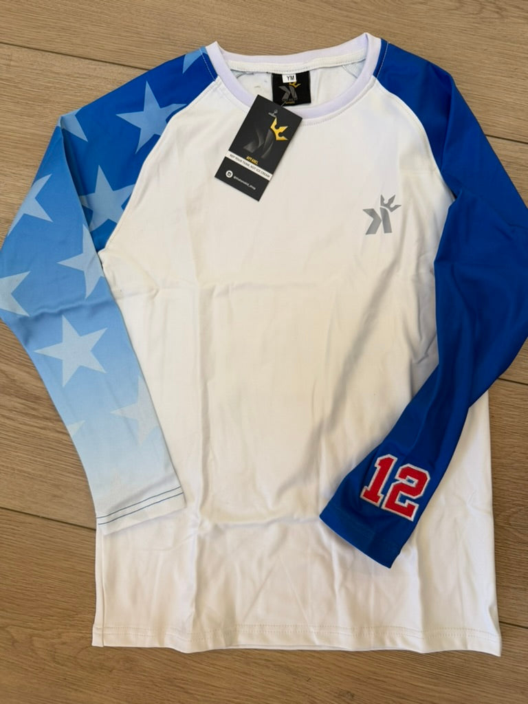 White long sleeve shirt with a blue star print sleeve and a solid blue sleeve featuring the number 12, laid flat on a wood floor.