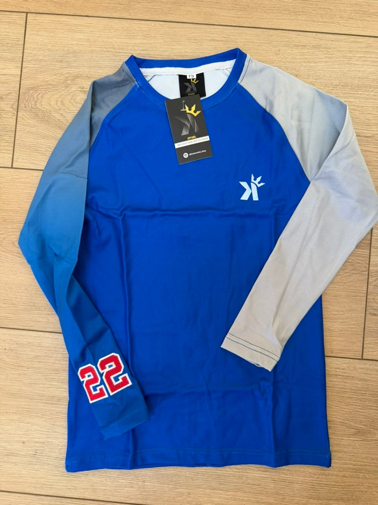 Royal blue long sleeve shirt with gray ombre sleeves and the number 22 in red on the cuff, laid flat on a wood floor.